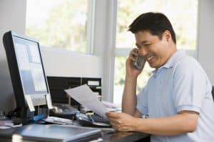 A man talking on the phone while working from home